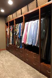 Solid wood closet organizer in cherry finish with drawers and hang bars