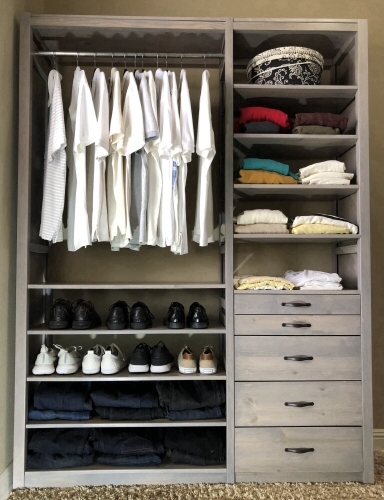 White solid wood closet organizer system with adjustable shelving